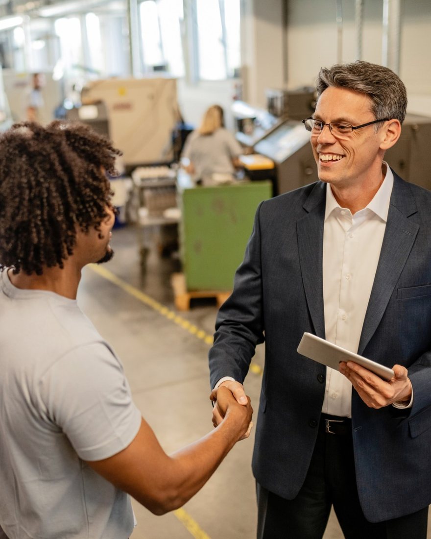 Packaging Exchange manager greeting a team member on a production floor